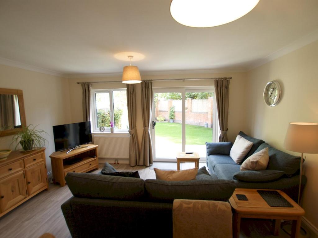 a living room with a couch and a tv at Pass the Keys Homely and central with parking in Exeter