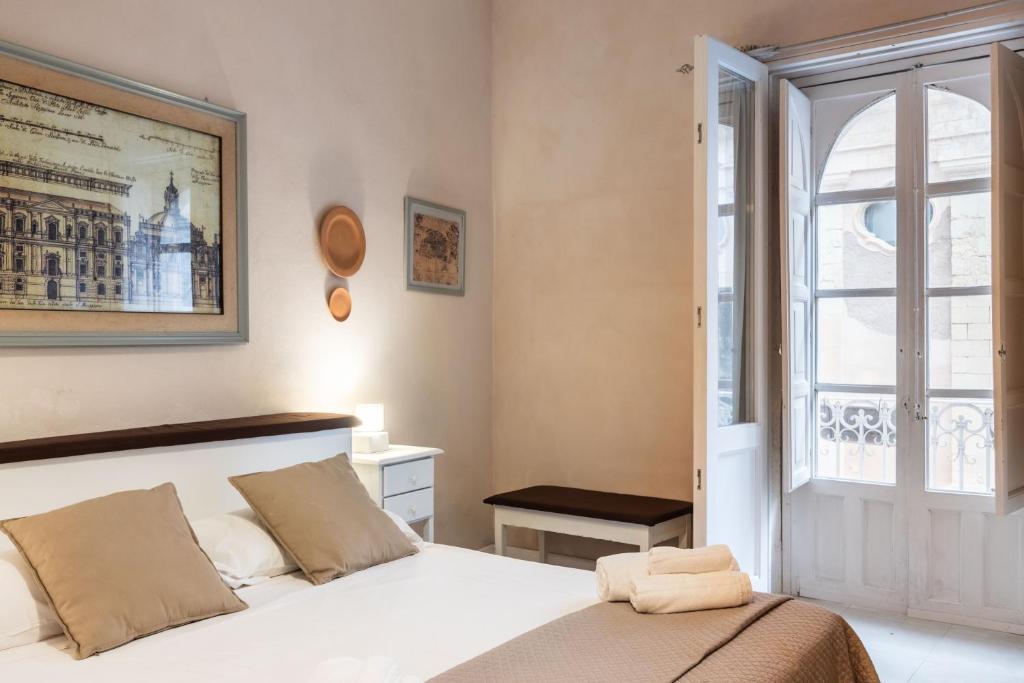 Postel nebo postele na pokoji v ubytování Dedalo Rooms