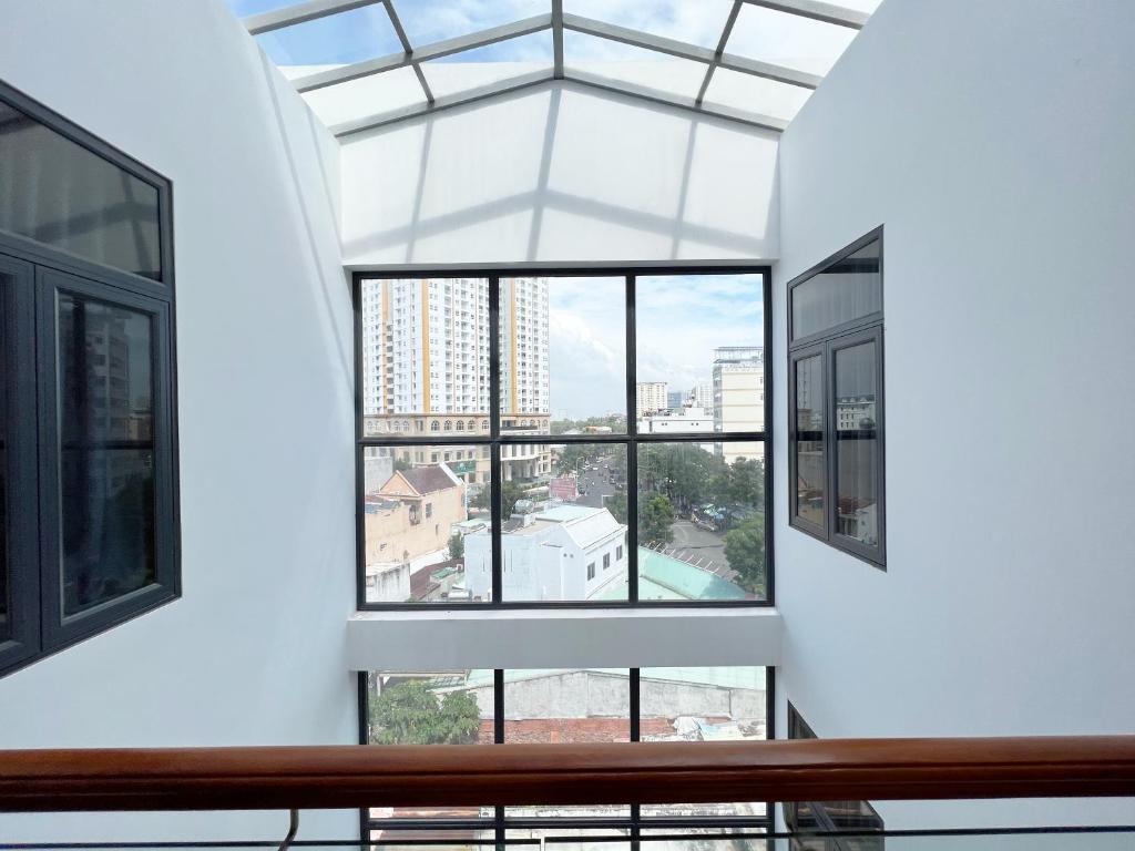 a window in a building with a view of a city at Rubillion Hotel - 5-Min Walking to Back Beach in Vung Tau