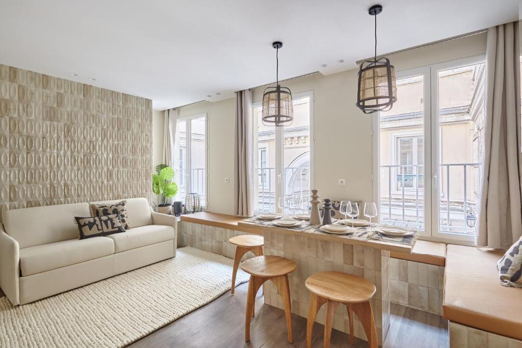 sala de estar con sofá y mesa en Residence Le Marais Beaubourg by Studio prestige, en París