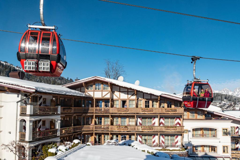 two ski lifts in front of a building at Hotel Kaiserhof Kitzbühel, 4 Sterne Superior in Kitzbühel