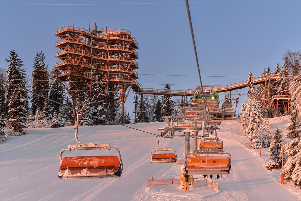 a ski lift with orange equipment in the snow at Słotwiny Arena in Krynica Zdrój