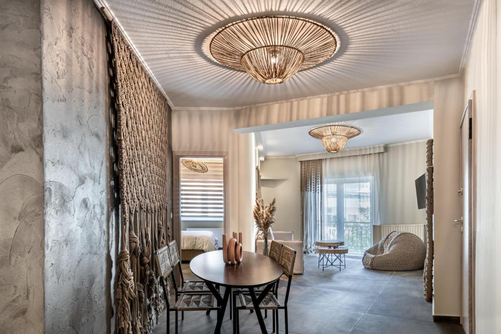 a living room with a table and a ceiling at Macrame Luxury Suites in Tríkala