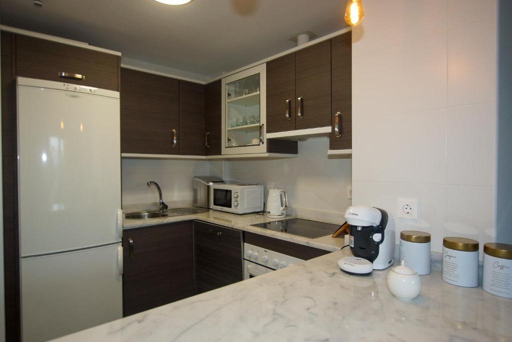 Kuchyň nebo kuchyňský kout v ubytování Small Oasis P&O Serviced Apartments