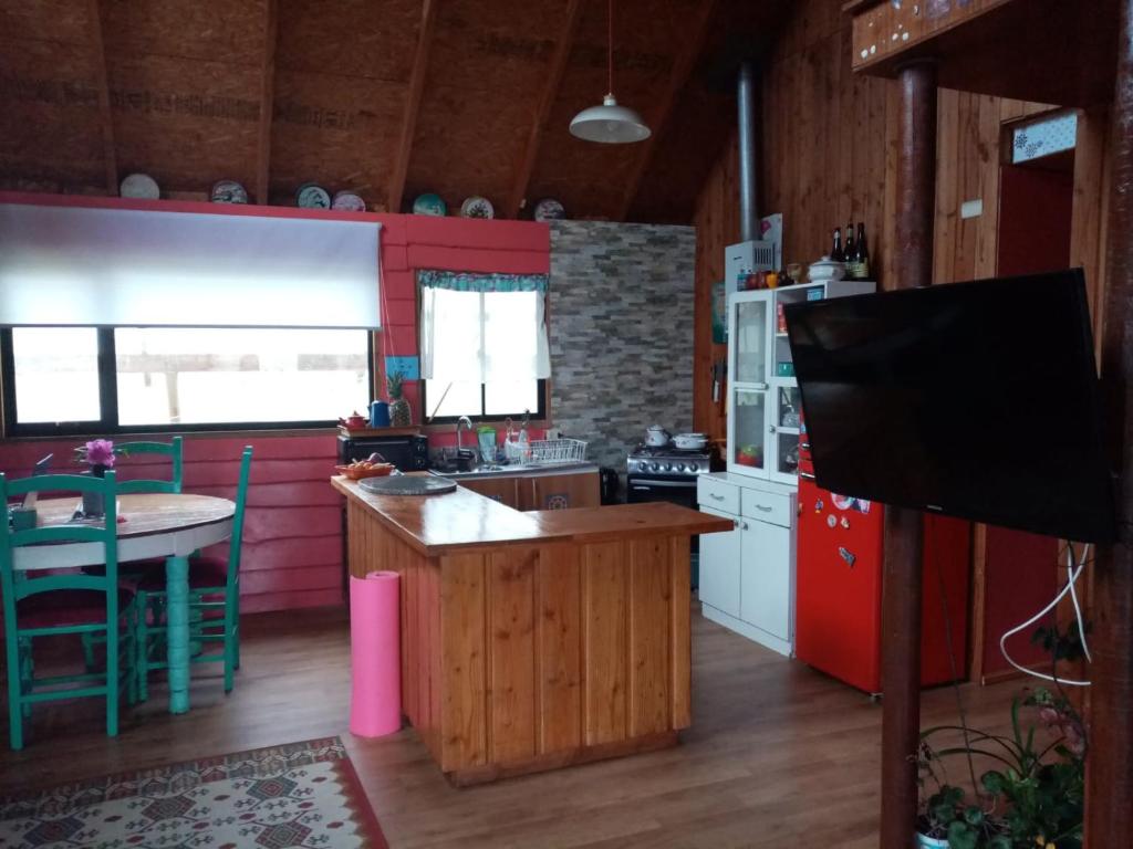 a kitchen with a table and a counter top at Cycling Hostel Piedra Azul in Puerto Montt
