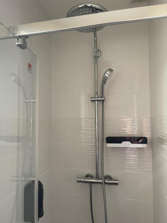 a shower with a glass door in a bathroom at Ty Enez Mor in Lanildut