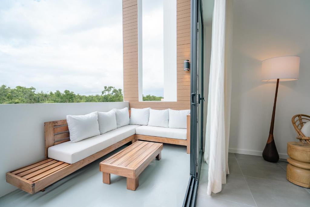 a living room with a couch and a table at Lumina at Flats Punta Cana Village in Punta Cana