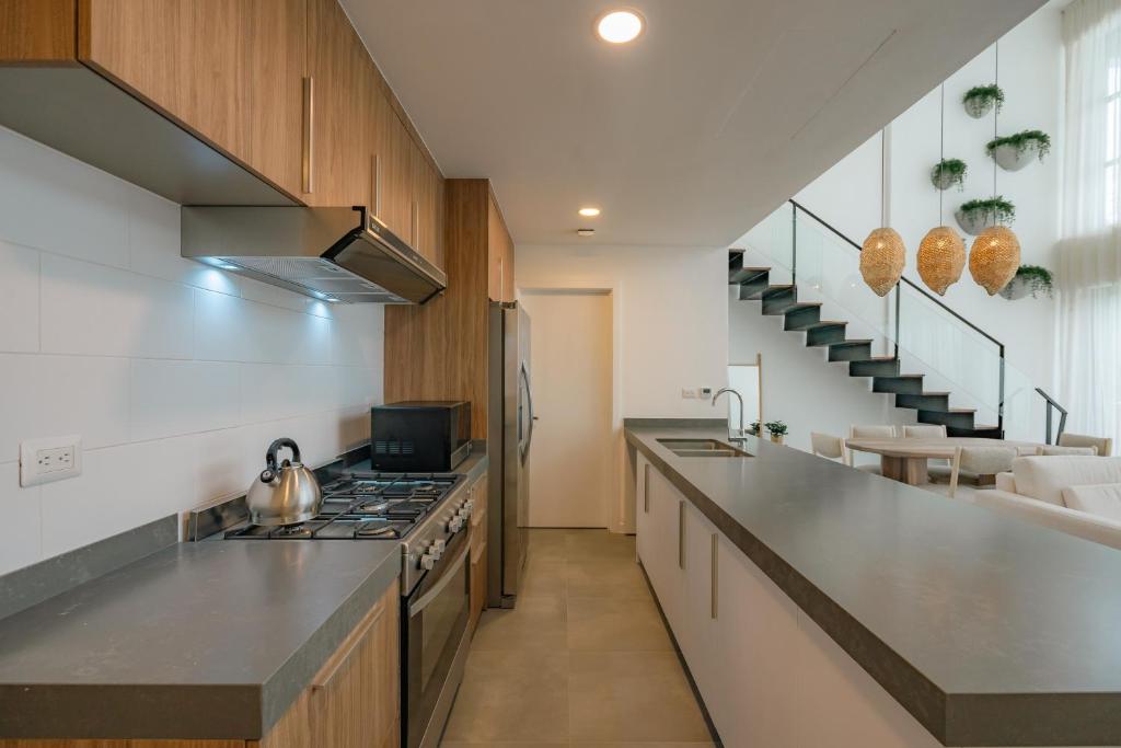 a kitchen with a stove and a counter top at Lumina at Flats Punta Cana Village in Punta Cana