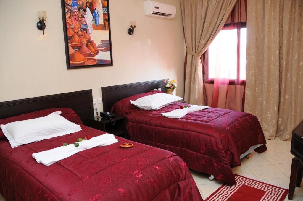 Postel nebo postele na pokoji v ubytování Residence Hotel Assounfou
