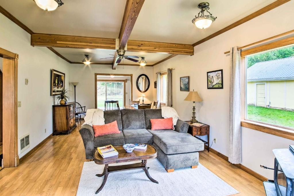una sala de estar con un sofá y una mesa en Quaint Coquille Getaway Near Beaches and Parks!, en Coquille