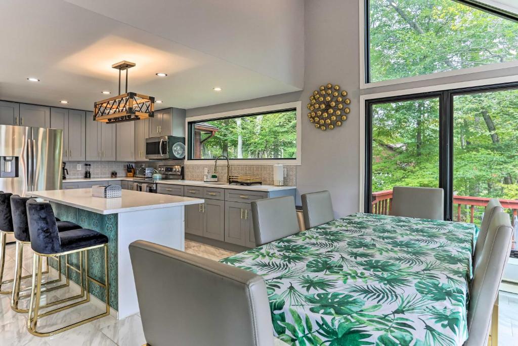 a kitchen and dining room with a table and chairs at Lakefront Catskills Getaway with Private Deck! in Forestburgh