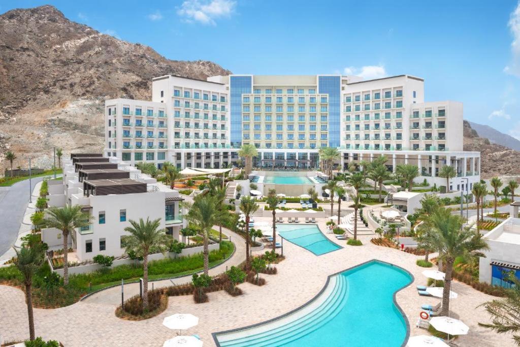 an aerial view of a resort with a swimming pool at Ocean Mountain View Apartment at The Address Fujairah in Fujairah