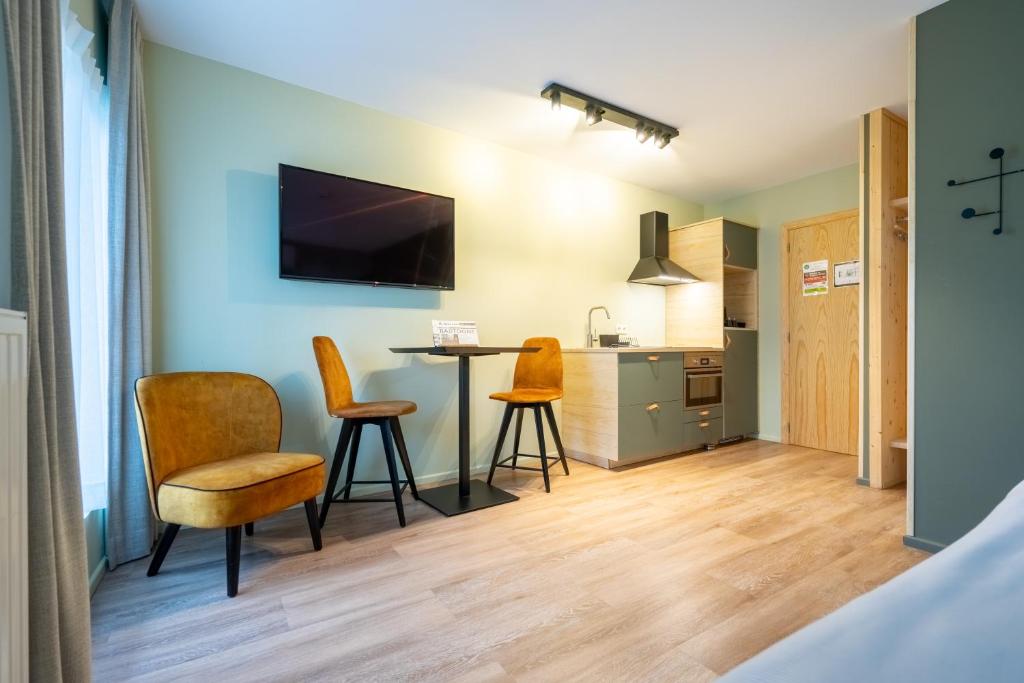 Kuchyň nebo kuchyňský kout v ubytování Appart hôtel En Ville