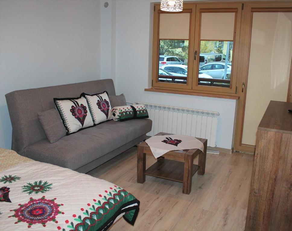 a living room with a couch and a table at Apartament Kaspruś in Zakopane