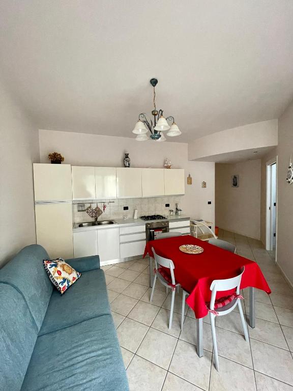 a living room with a blue couch and a red table at Appartamento ' Il sole di Vale' in Loano