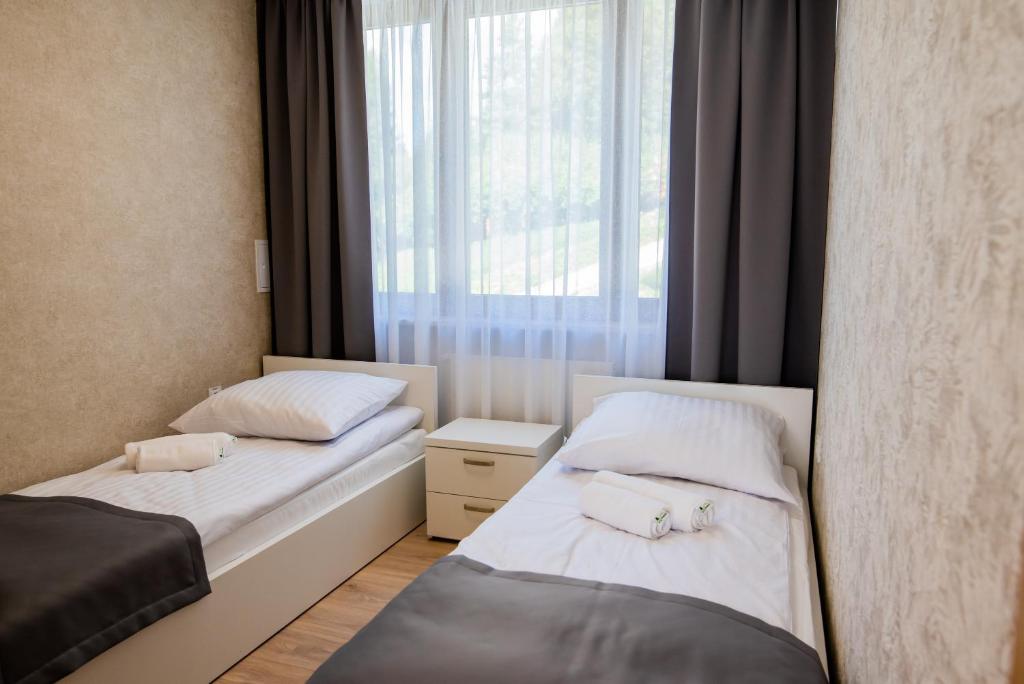 Postel nebo postele na pokoji v ubytování Apartamenty Leśne Zacisze