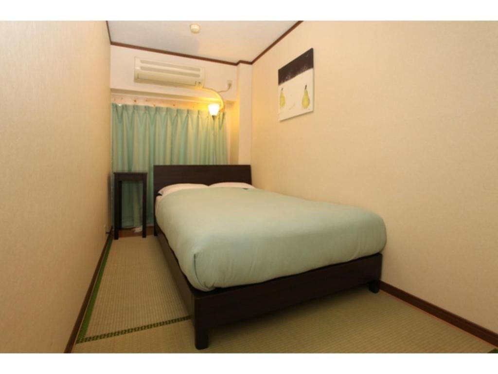 a small bedroom with a bed in a room at Hostel Zen - Vacation STAY 91859v in Yokohama