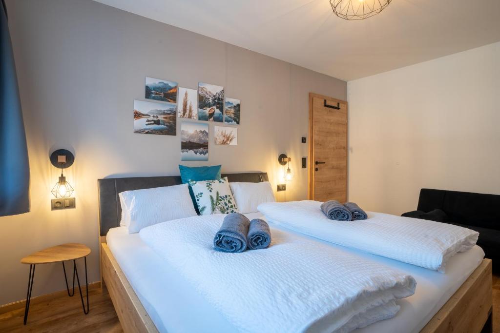 a bedroom with two beds with towels on them at Apartment Waldherz in Wald im Pinzgau