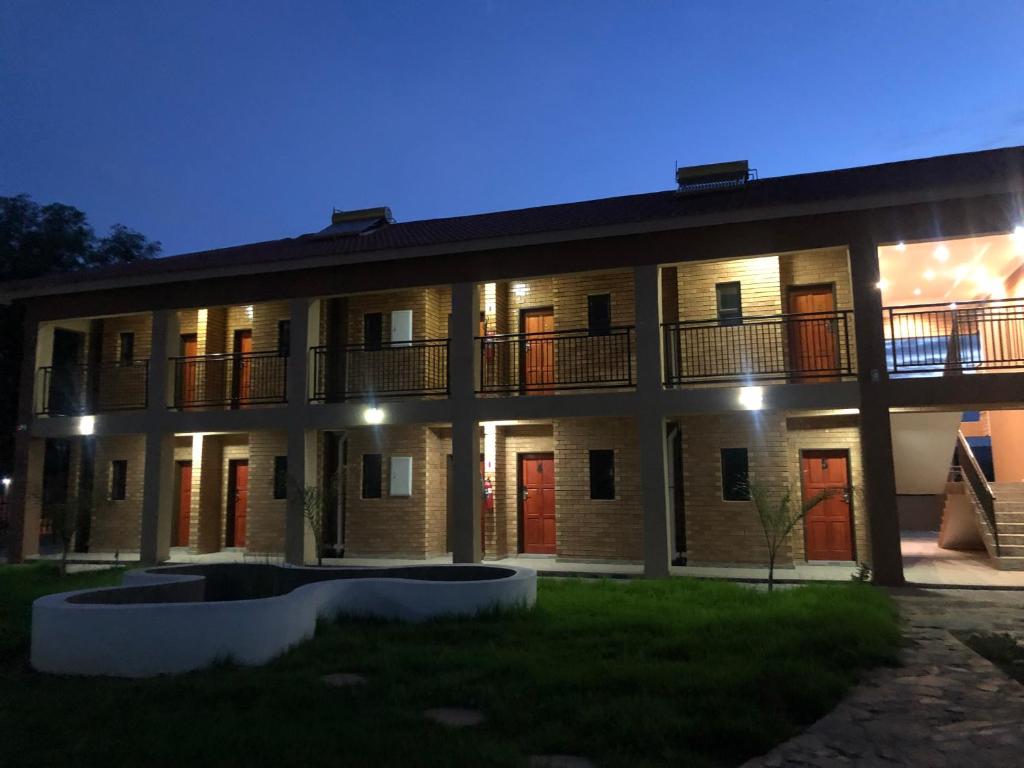 a large building with red doors at night at Avrila Springs Hotel in Gaborone