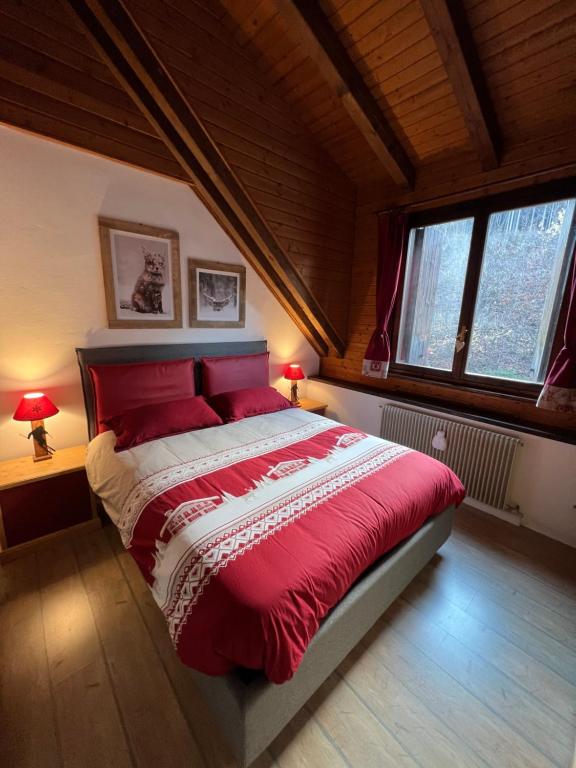 a bedroom with a large red bed with two lamps at Mandi Mandi a Tarvisio in Tarvisio