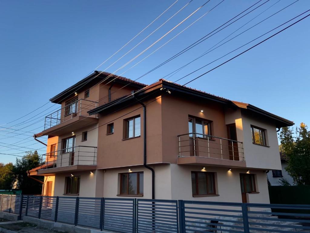 a house with a fence in front of it at Villa Stoyanovata Kashta in Samokov