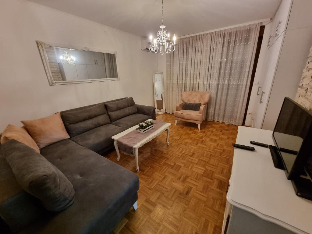 a living room with a couch and a table at Apartman Danijela in Vukovar
