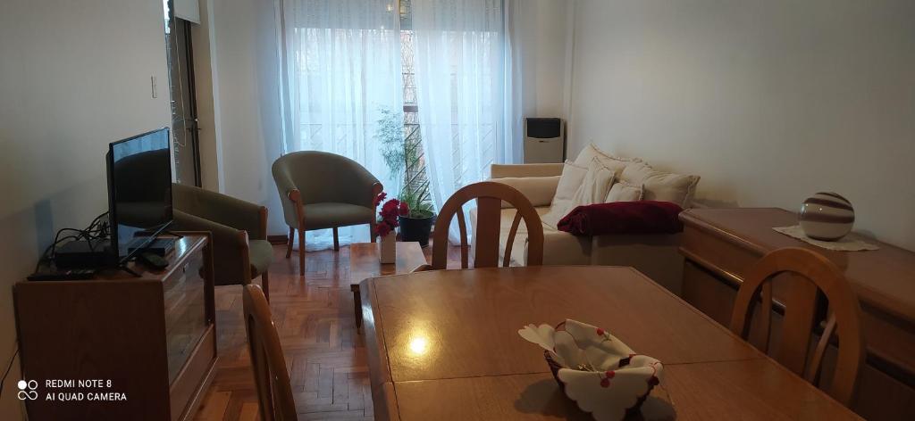 a living room with a table and a living room with a couch at Coiron in Puerto Madryn