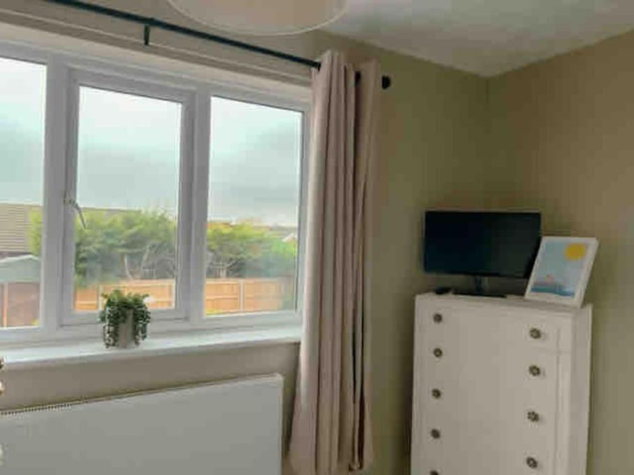 a room with a window and a television on a dresser at Mews house 5 minutes walk from the sea in Cleethorpes