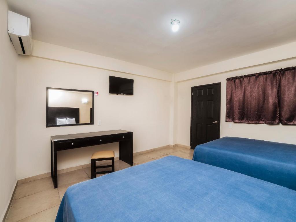 Postel nebo postele na pokoji v ubytování Hotel Puerto Inn