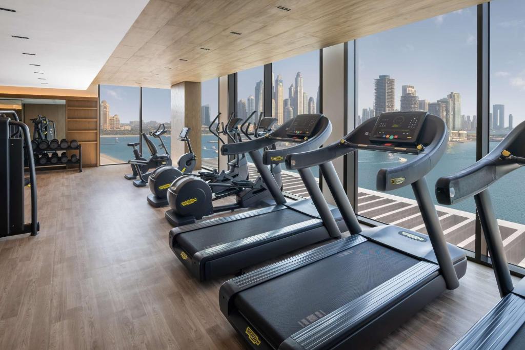a gym with a row of treadmills at Radisson Beach Resort Palm Jumeirah in Dubai