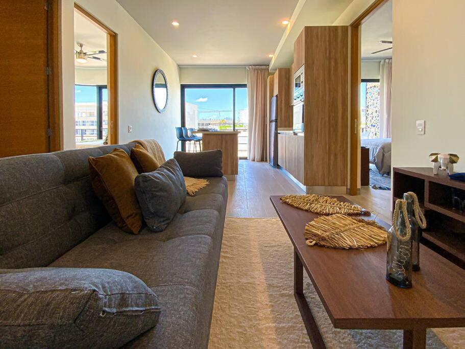 a living room with a couch and a table at Beautiful + Luxury + Ocean View + Pool in Playa del Carmen