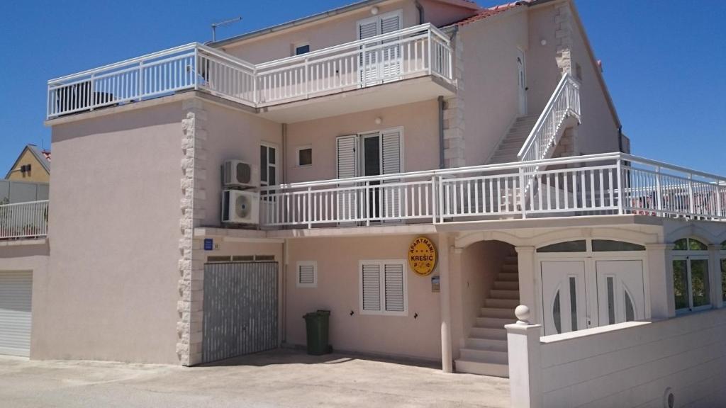 a white house with a balcony on top of it at Apartments and rooms with WiFi Hvar - 20114 in Hvar