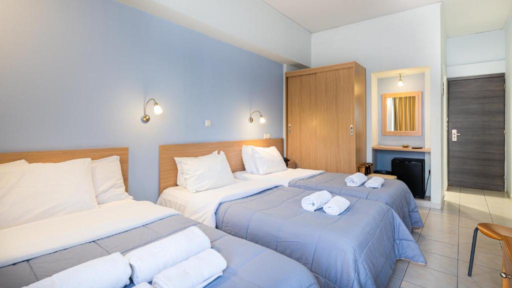 Ένα ή περισσότερα κρεβάτια σε δωμάτιο στο Diros Hotel