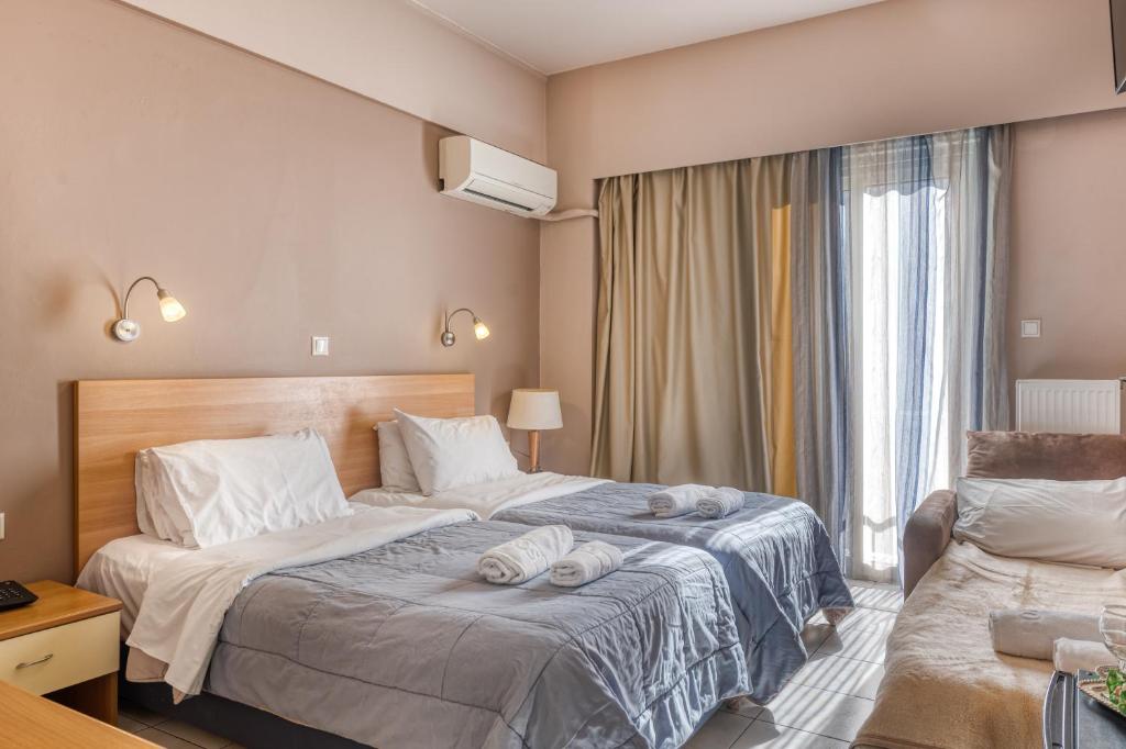 Ένα ή περισσότερα κρεβάτια σε δωμάτιο στο Diros Hotel
