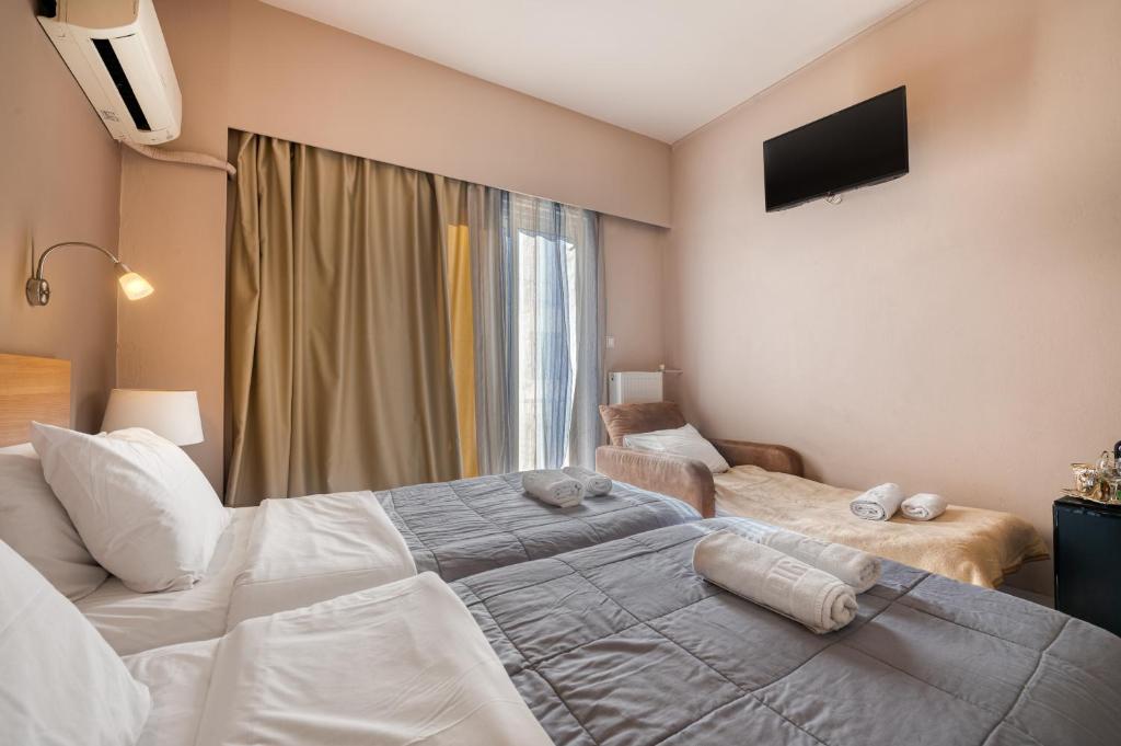 Ένα ή περισσότερα κρεβάτια σε δωμάτιο στο Diros Hotel