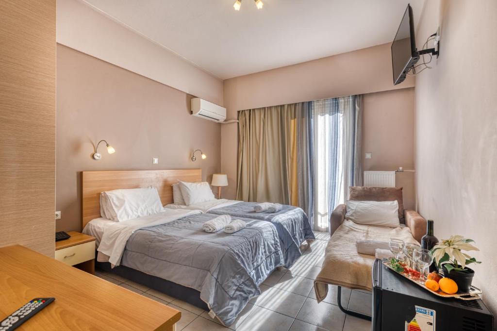 Ένα ή περισσότερα κρεβάτια σε δωμάτιο στο Diros Hotel