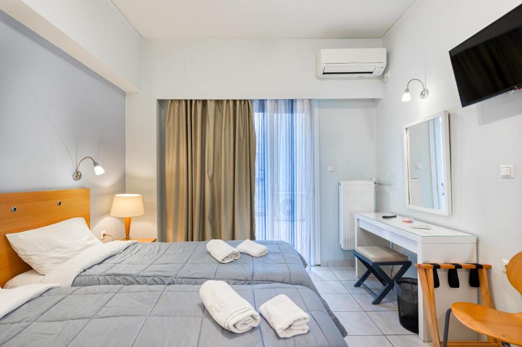 Ένα ή περισσότερα κρεβάτια σε δωμάτιο στο Diros Hotel