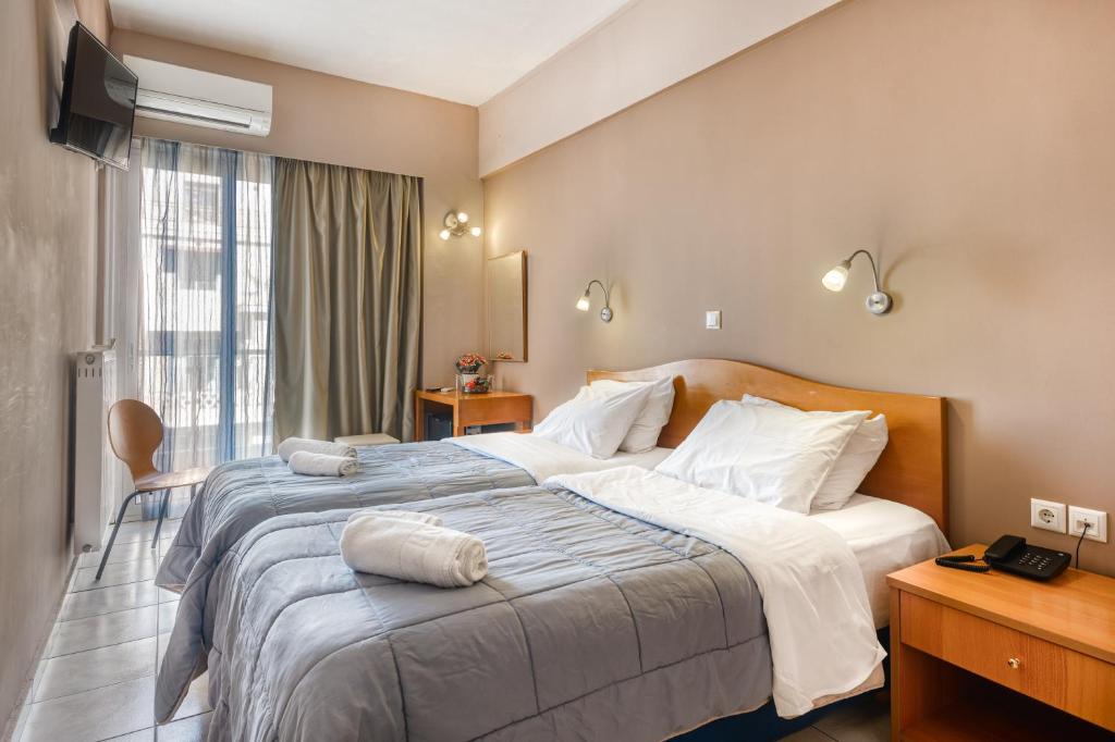 Ένα ή περισσότερα κρεβάτια σε δωμάτιο στο Diros Hotel