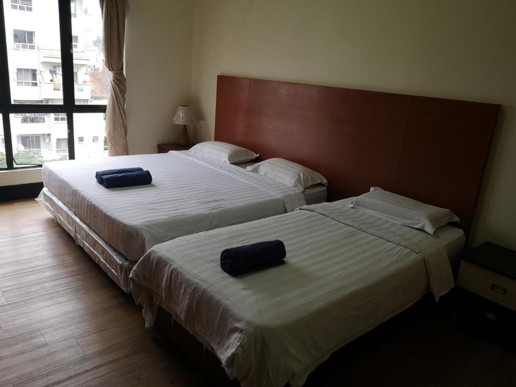 Voodi või voodid majutusasutuse Marina Court KK City Homestay toas