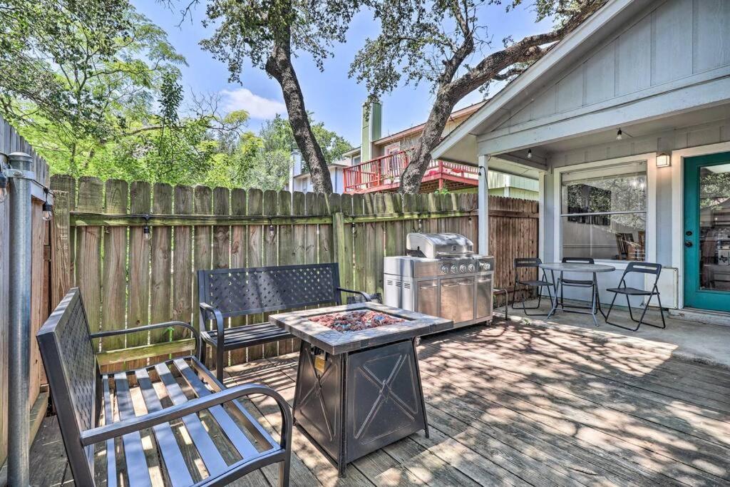 a backyard with two benches and a grill and a fence at NEW! ATX Home with 3 Patios, 3 TVs, & Fire Pit in Austin