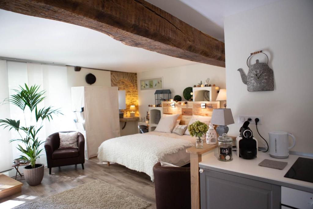 a bedroom with a bed and a desk in a room at Le Clos de la Chouette in Pommard