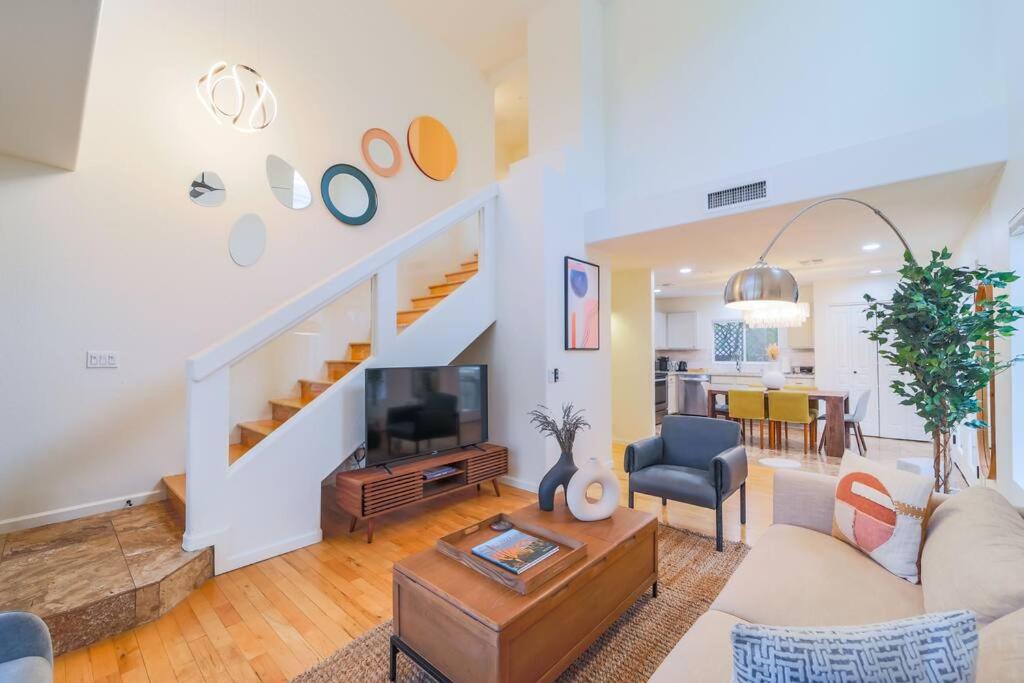 a living room with a couch and a staircase at Westworld, TPC Golf, Hiking in Your Backyard! in Scottsdale