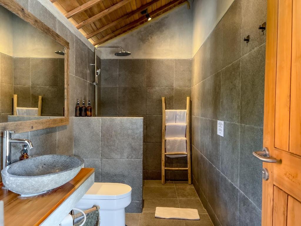 a bathroom with a sink and a toilet at Diamond Beach Villas in Nusa Penida