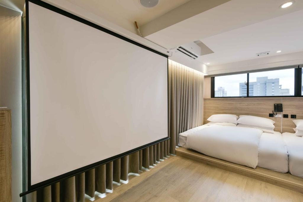 Postel nebo postele na pokoji v ubytování Spring Rhapsody Hotel
