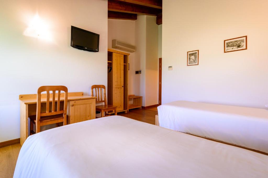 Postel nebo postele na pokoji v ubytování Agriturismo Nonis