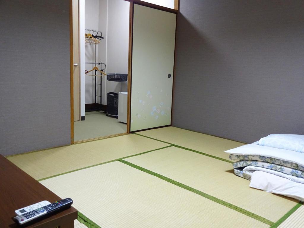 Postel nebo postele na pokoji v ubytování Imazato Ryokan