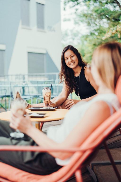 two women sitting at a table in a restaurant at Airbase Hotel in Kalsdorf bei Graz