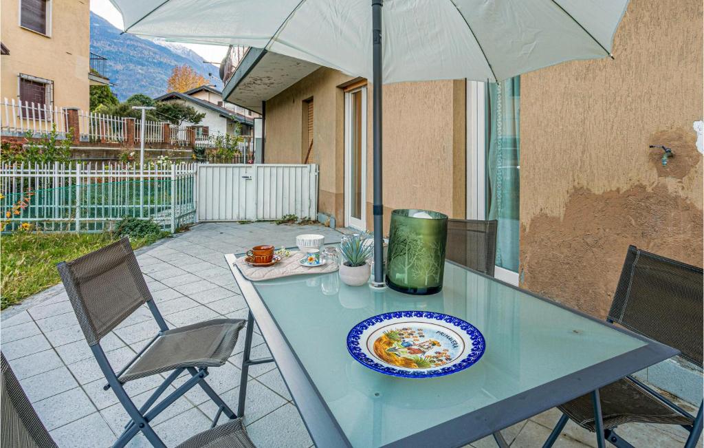a table with a plate of food and an umbrella at Nice Apartment In Chatillon With Wifi in Châtillon
