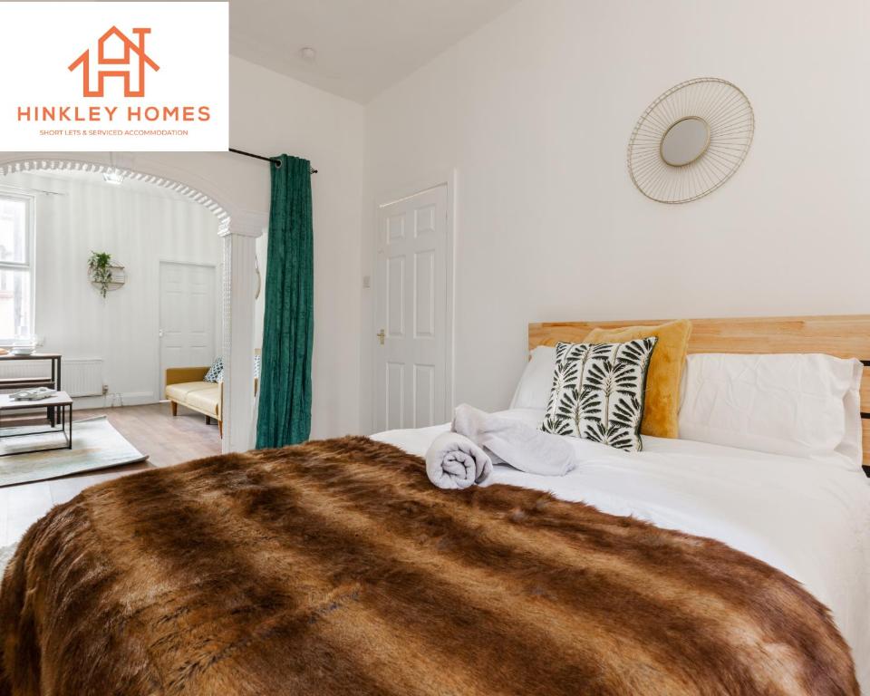 a bedroom with a large bed with a brown blanket at Stanley House - 7 doubles! - Parking! - City Links By Hinkley Homes Short Lets & Serviced Accommodation in Liverpool