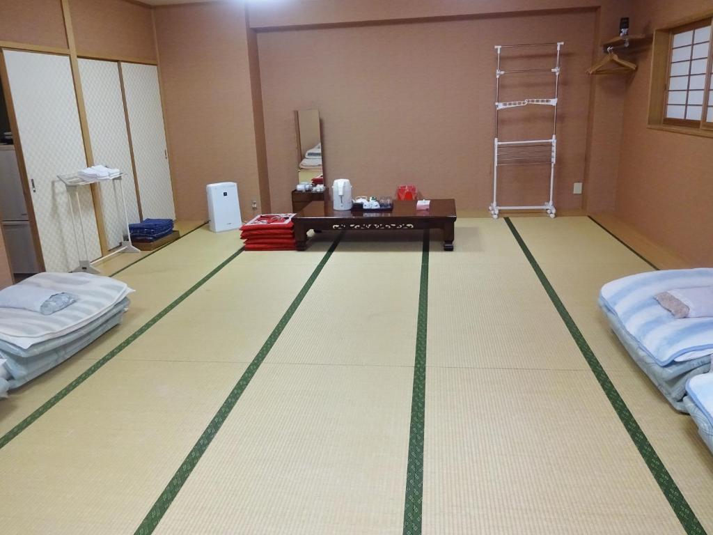 Postel nebo postele na pokoji v ubytování Imazato Ryokan
